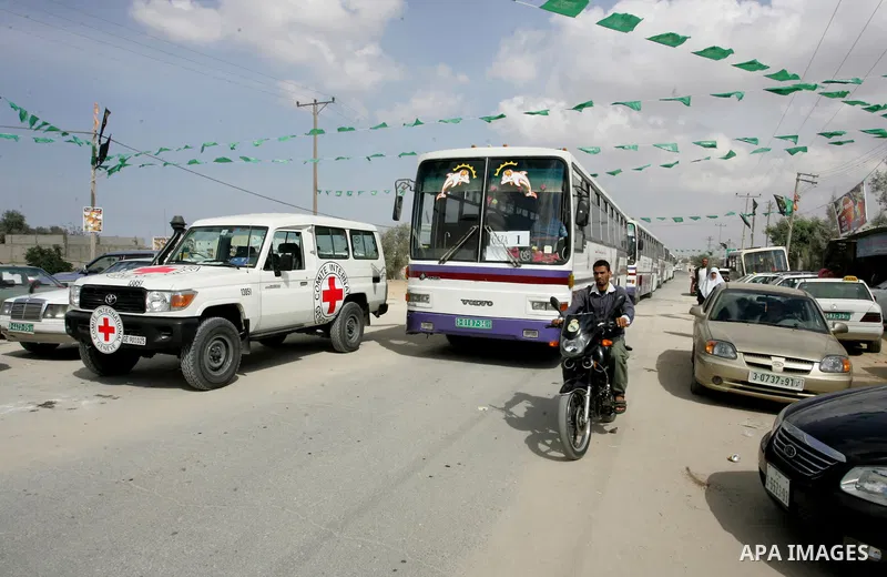 Red Cross vehicles and buses arrive from Egypt to the Rafah crossing in the southern Gaza Strip on Oct, 17. 2011 for the upcoming transfer of Palestinian prisoners from Israel to Gaza . Under a prisoner swap deal signed...