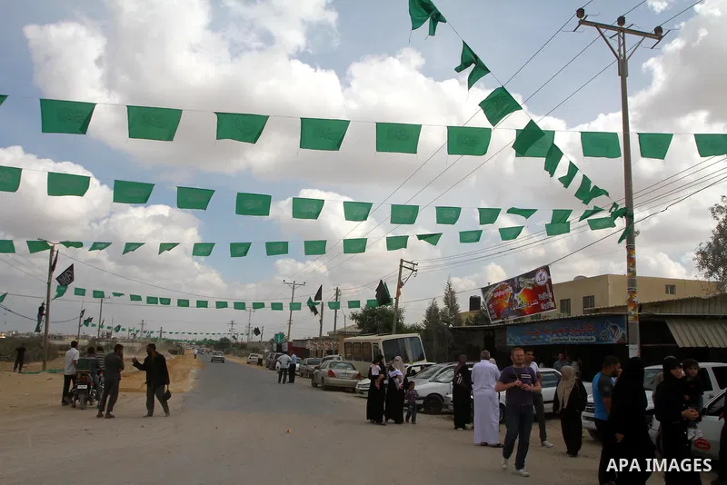Palestinians gather at the Rafah border crossing in the southern Gaza Strip October 17, 2011, during preparations for the release of prisoners in a swap that is expected to take place on Tuesday. Hamas prepared a heroes'...