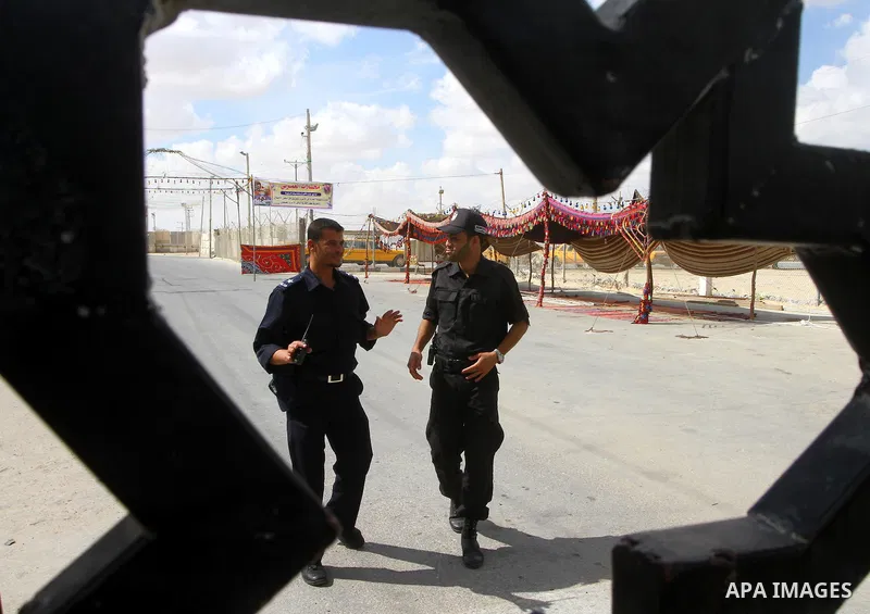 Palestinian Hamas policemen stand guard at the Rafah border crossing in the southern Gaza Strip October 17, 2011, during preparations for the release of prisoners in a swap that is expected to take place on Tuesday. Hama...