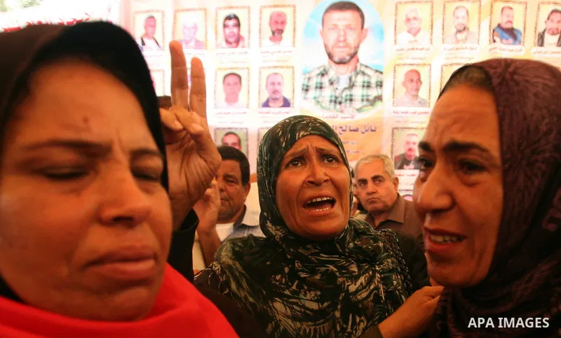 Palestinians gather during a protest at the Red Cross' offices in Gaza City to call for the release of Palestinian prisoners held in Israeli jails, on October 17, 2011. Under a prisoner swap deal signed with Israel, the...