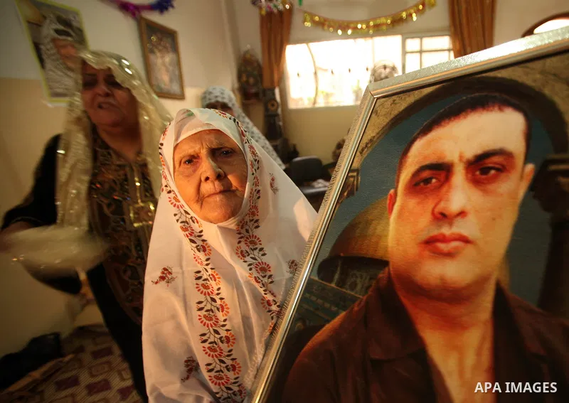The family of Palestinian prisoner Raafat Aroki gather at a relative's house in the Gaza Strip on 17 October 2011 as they await his release as part of a deal to secure the exchange of Israeli captive soldier Gilad Shalit...