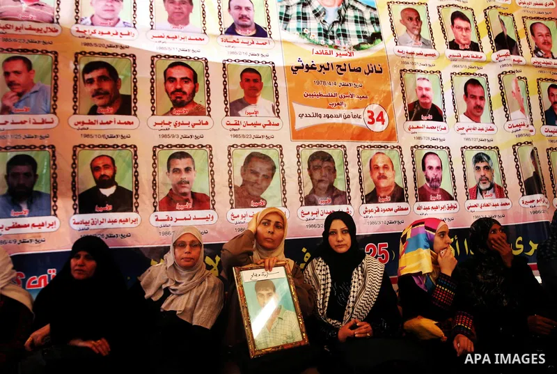 Palestinians gather during a protest at the Red Cross' offices in Gaza City to call for the release of Palestinian prisoners held in Israeli jails, on October 17, 2011. Under a prisoner swap deal signed with Israel, the...