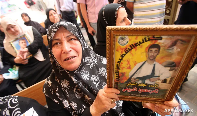 Palestinians gather during a protest at the Red Cross' offices in Gaza City to call for the release of Palestinian prisoners held in Israeli jails, on October 17, 2011. Under a prisoner swap deal signed with Israel, the...