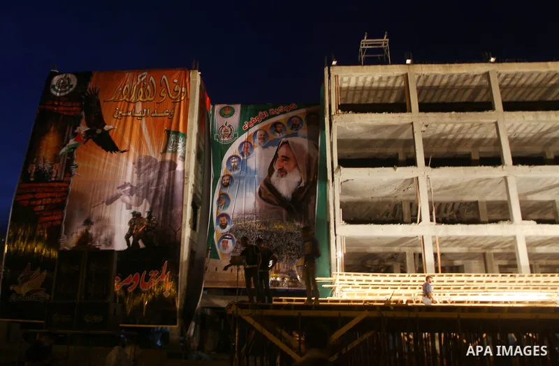 Palestinian men work on the stage that will be used to welcome prisoners released in the swap with Israel in Gaza City, Monday, Oct. 17, 2011. The elaborate machinery of a prisoner swap deal between two bitter enemies sw...