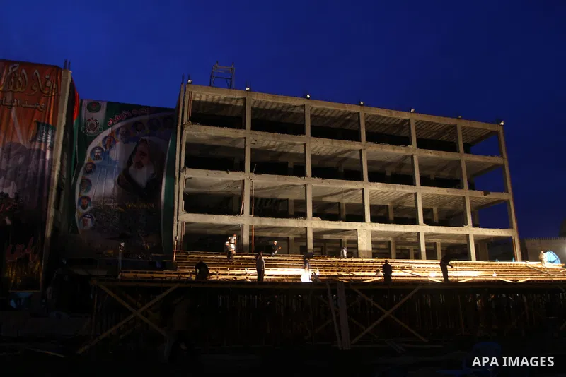 Palestinian men work on the stage that will be used to welcome prisoners released in the swap with Israel in Gaza City, Monday, Oct. 17, 2011. The elaborate machinery of a prisoner swap deal between two bitter enemies sw...