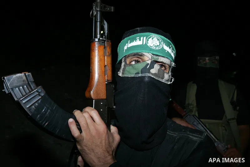 Palestinian Hamas militants stand guard on the main road in Khan Younis, southern Gaza Strip, Monday, Oct. 17, 2011. The exchange between Israel and Hamas in which 1,027 Palestinian prisoners will be released for capture...