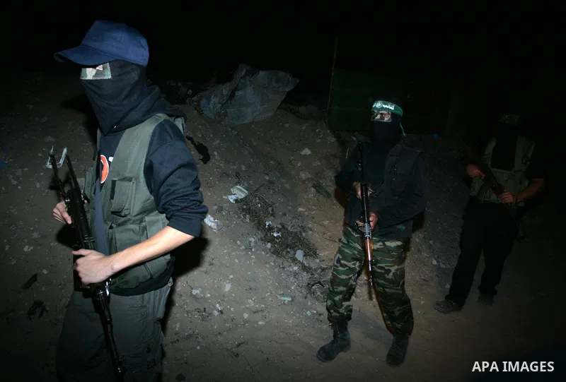 Palestinian Hamas militants stand guard on the main road in Khan Younis, southern Gaza Strip, Monday, Oct. 17, 2011. The exchange between Israel and Hamas in which 1,027 Palestinian prisoners will be released for capture...
