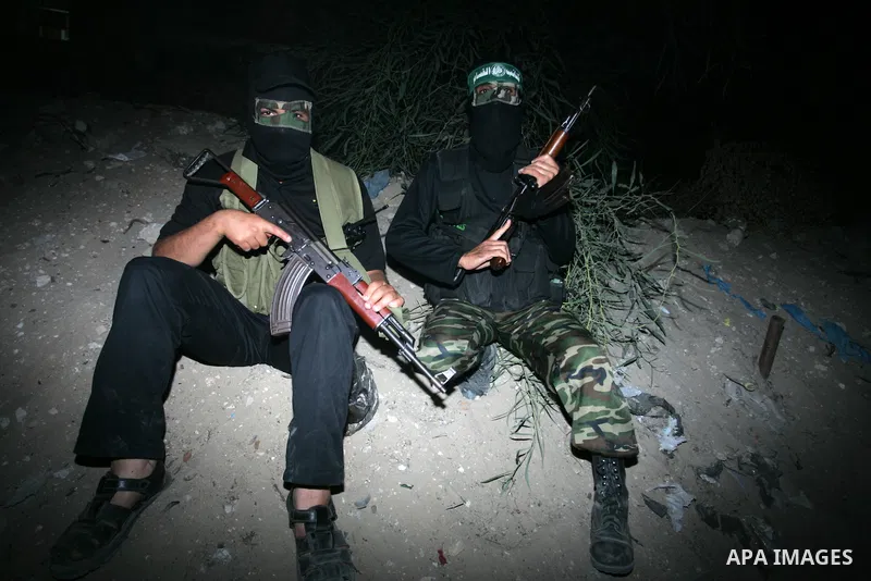 Palestinian Hamas militants stand guard on the main road in Khan Younis, southern Gaza Strip, Monday, Oct. 17, 2011. The exchange between Israel and Hamas in which 1,027 Palestinian prisoners will be released for capture...