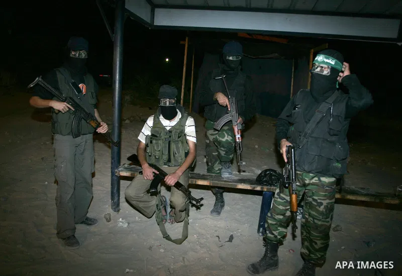 Palestinian Hamas militants stand guard on the main road in Khan Younis, southern Gaza Strip, Monday, Oct. 17, 2011. The exchange between Israel and Hamas in which 1,027 Palestinian prisoners will be released for capture...