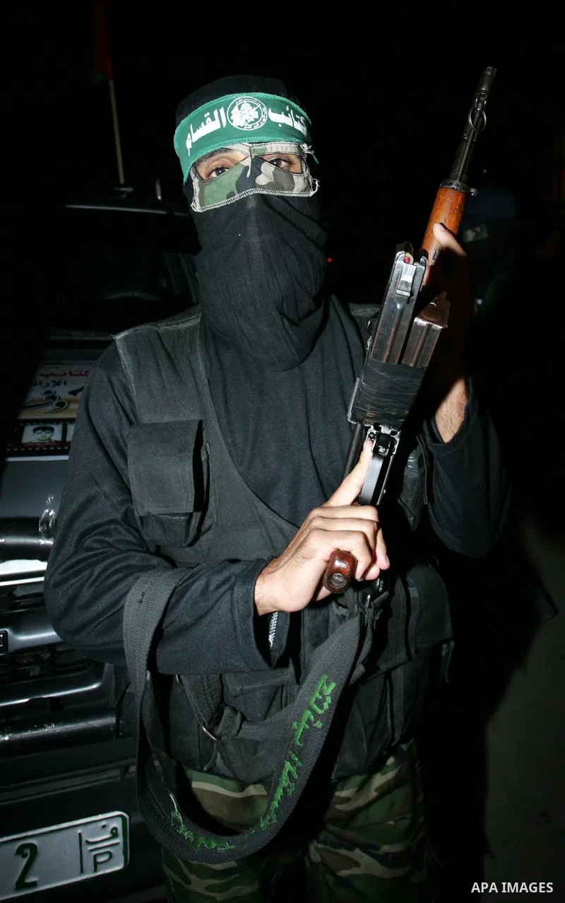 Palestinian Hamas militants stand guard on the main road in Khan Younis, southern Gaza Strip, Monday, Oct. 17, 2011. The exchange between Israel and Hamas in which 1,027 Palestinian prisoners will be released for capture...