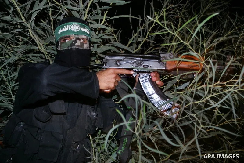 Palestinian Hamas militants stand guard on the main road in Khan Younis, southern Gaza Strip, Monday, Oct. 17, 2011. The exchange between Israel and Hamas in which 1,027 Palestinian prisoners will be released for capture...