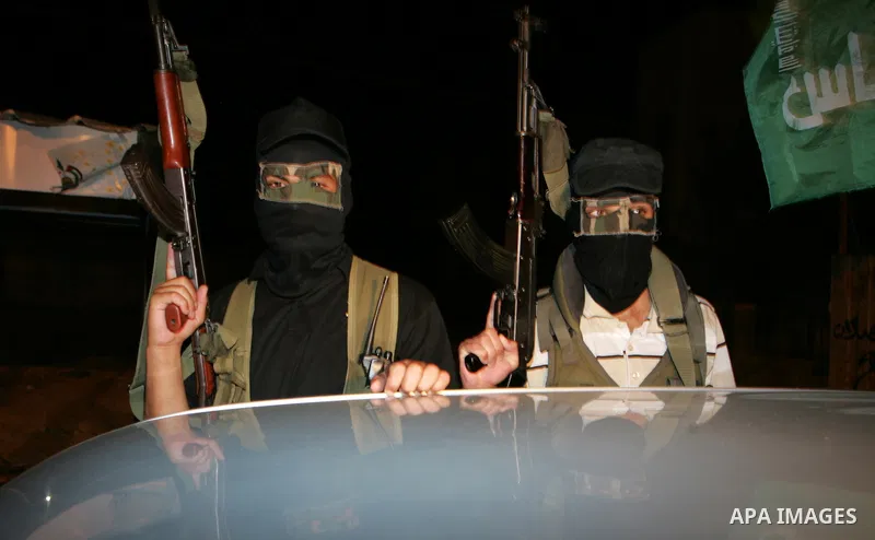 Palestinian Hamas militants stand guard on the main road in Khan Younis, southern Gaza Strip, Monday, Oct. 17, 2011. The exchange between Israel and Hamas in which 1,027 Palestinian prisoners will be released for capture...