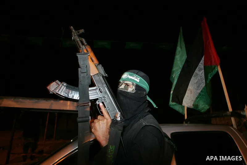 Palestinian Hamas militants stand guard on the main road in Khan Younis, southern Gaza Strip, Monday, Oct. 17, 2011. The exchange between Israel and Hamas in which 1,027 Palestinian prisoners will be released for capture...