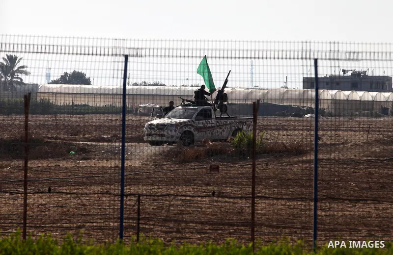 Armed Palestinian Hamas militants keep patrol near the Rafah crossing with Egypt in the southern Gaza Strip on October 18, 2011 as an Israeli-Palestinian prisoner swap deal gets under way. Buses carrying 477 Palestinian...