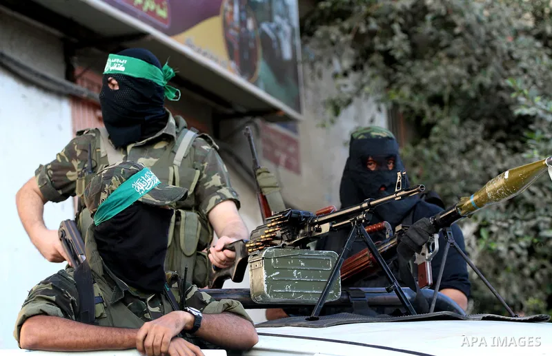 Armed Palestinian Hamas militants stand guard at a street in Gaza city on October 18, 2011 as an Israeli-Palestinian prisoner swap deal gets under way. Buses carrying 477 Palestinian prisoners were headed for Gaza and th...