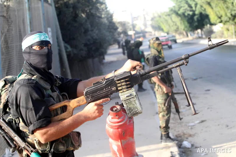Armed Palestinian Hamas militants stand guard at a street in Gaza city on October 18, 2011 as an Israeli-Palestinian prisoner swap deal gets under way. Buses carrying 477 Palestinian prisoners were headed for Gaza and th...