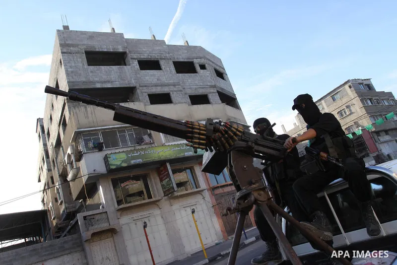 Armed Palestinian Hamas militants stand guard at a street in Gaza city on October 18, 2011 as an Israeli-Palestinian prisoner swap deal gets under way. Buses carrying 477 Palestinian prisoners were headed for Gaza and th...