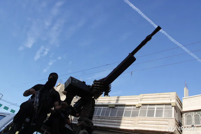 Armed Palestinian Hamas militants stand guard at a street in Gaza city on October 18, 2011 as an Israeli-Palestinian prisoner swap deal gets under way. Buses carrying 477 Palestinian prisoners were headed for Gaza and th...