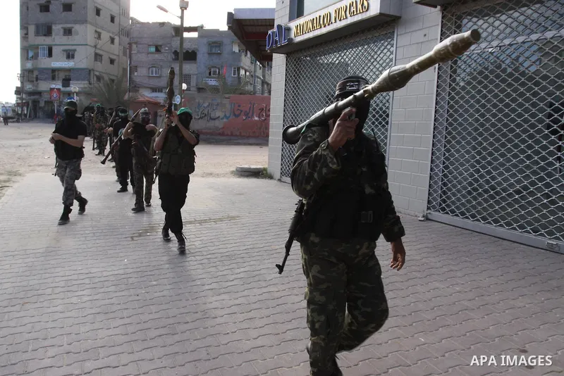 Armed Palestinian Hamas militants stand guard at a street in Gaza city on October 18, 2011 as an Israeli-Palestinian prisoner swap deal gets under way. Buses carrying 477 Palestinian prisoners were headed for Gaza and th...
