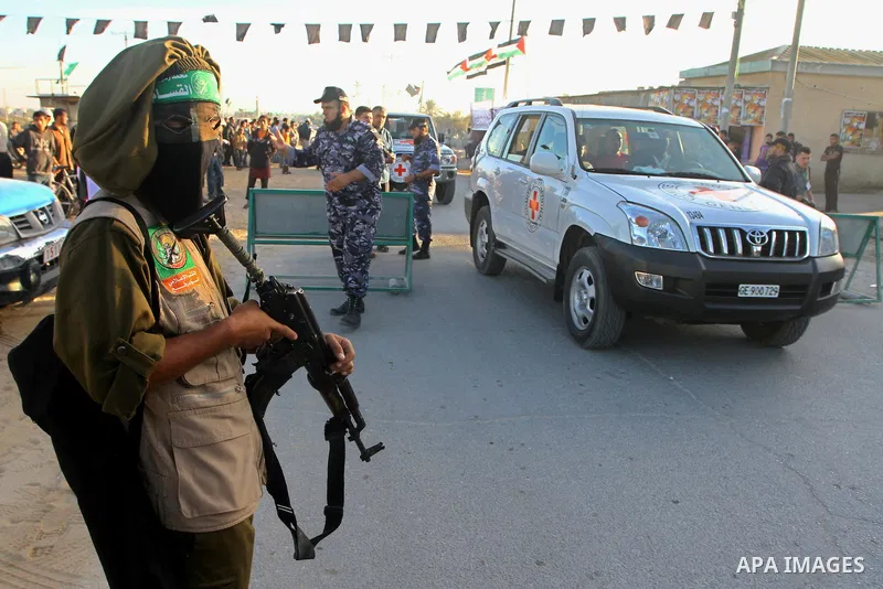 An armed Palestinian Hamas militant keeps watch near the Rafah Crossing through which Palestinian prisoners about to be freed in a prisoner swap between Hamas and Israel, will enter Gaza, in the southern Gaza Strip as an...