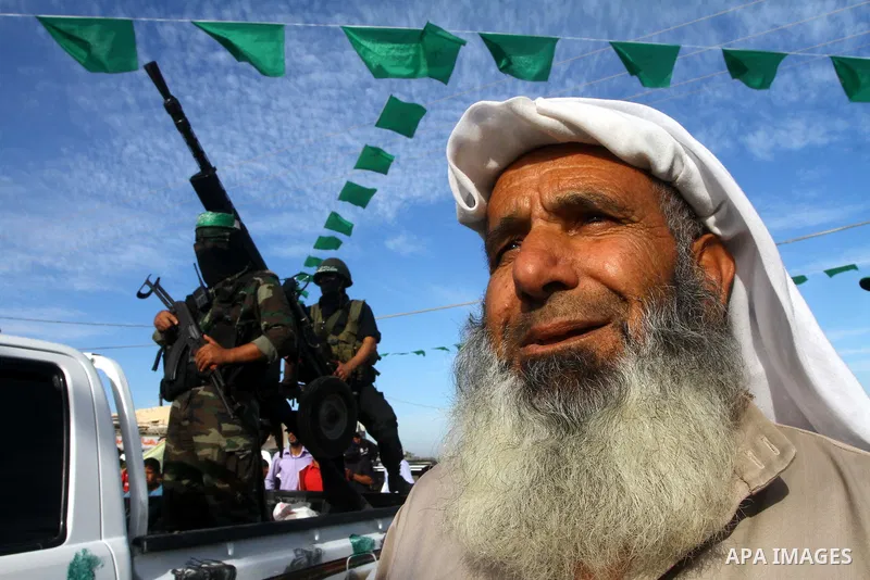 Armed Palestinian Hamas militants keep watch near the Rafah crossing with Egypt in the southern Gaza Strip on October 18, 2011 as an Israeli-Palestinian prisoner swap deal gets under way. Buses carrying 477 Palestinian p...