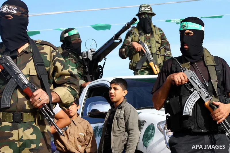 Armed Palestinian Hamas militants keep watch near the Rafah crossing with Egypt in the southern Gaza Strip on October 18, 2011 as an Israeli-Palestinian prisoner swap deal gets under way. Buses carrying 477 Palestinian p...