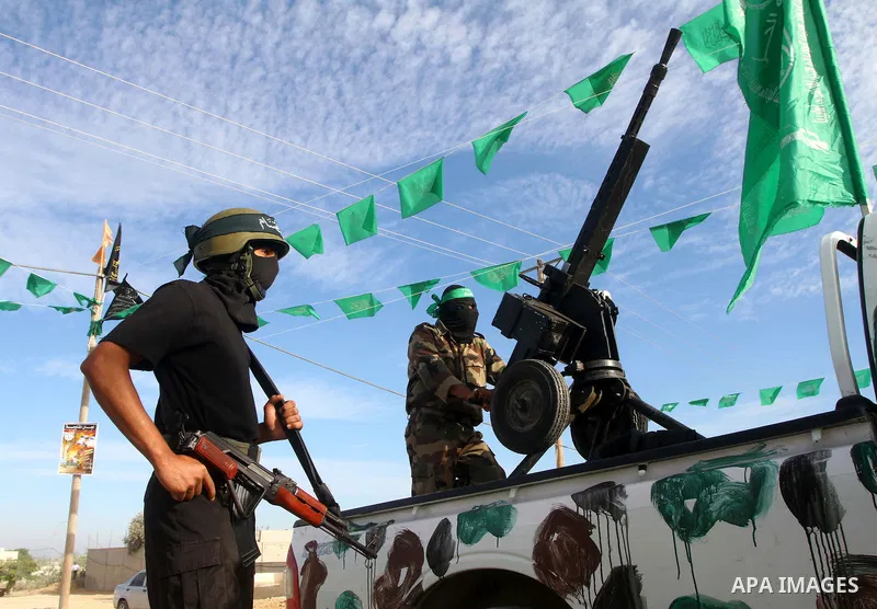 Armed Palestinian Hamas militants keep watch near the Rafah crossing with Egypt in the southern Gaza Strip on October 18, 2011 as an Israeli-Palestinian prisoner swap deal gets under way. Buses carrying 477 Palestinian p...