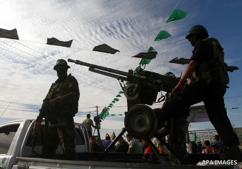 Armed Palestinian Hamas militants keep watch near the Rafah crossing with Egypt in the southern Gaza Strip on October 18, 2011 as an Israeli-Palestinian prisoner swap deal gets under way. Buses carrying 477 Palestinian p...
