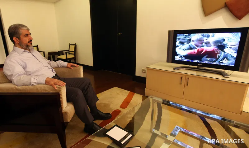 Palestinian Hamas leader Khaled Meshaal watches TV in at his residential headquarters in Cairo, Egypt Oct. 18,2011. Gaza's Hamas Islamist rulers released captured Israeli soldier Gilad Shalit on Tuesday in return for hun...