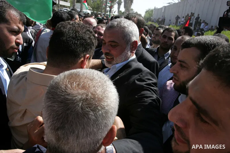 Palestinian Prime Minister in Gaza Strip, Ismail Haniyeh greets a released Palestinian prisoner at the Rafah border crossing in southern Gaza Strip, Tuesday, Oct. 18, 2011. The Hamas militant group released an Israeli so...