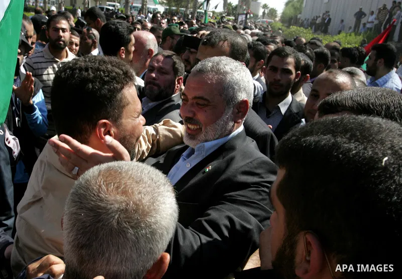 Palestinian Prime Minister in Gaza Strip, Ismail Haniyeh greets a released Palestinian prisoner at the Rafah border crossing in southern Gaza Strip, Tuesday, Oct. 18, 2011. The Hamas militant group released an Israeli so...
