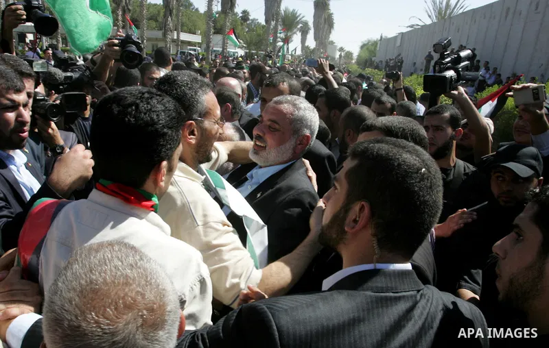 Palestinian Prime Minister in Gaza Strip, Ismail Haniyeh greets a released Palestinian prisoner at the Rafah border crossing in southern Gaza Strip, Tuesday, Oct. 18, 2011. The Hamas militant group released an Israeli so...