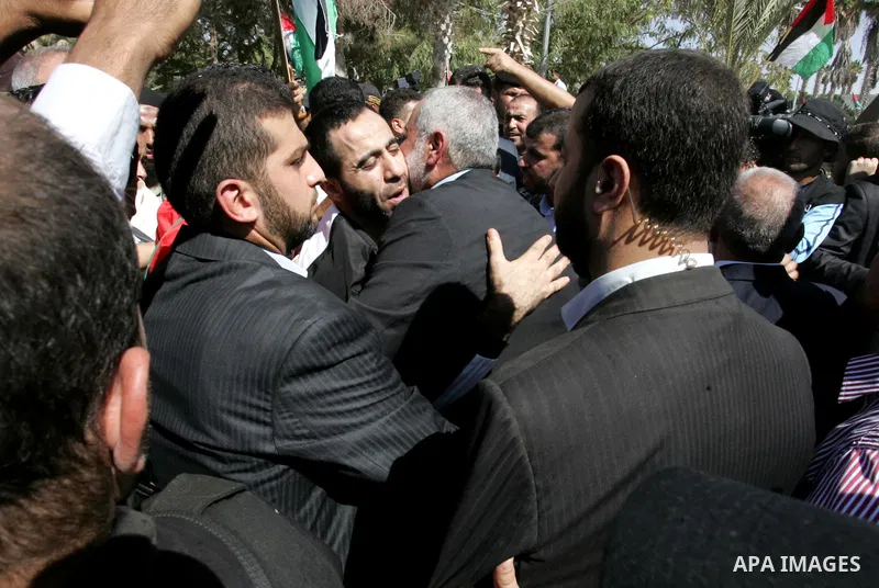 Palestinian Prime Minister in Gaza Strip, Ismail Haniyeh greets a released Palestinian prisoner at the Rafah border crossing in southern Gaza Strip, Tuesday, Oct. 18, 2011. The Hamas militant group released an Israeli so...