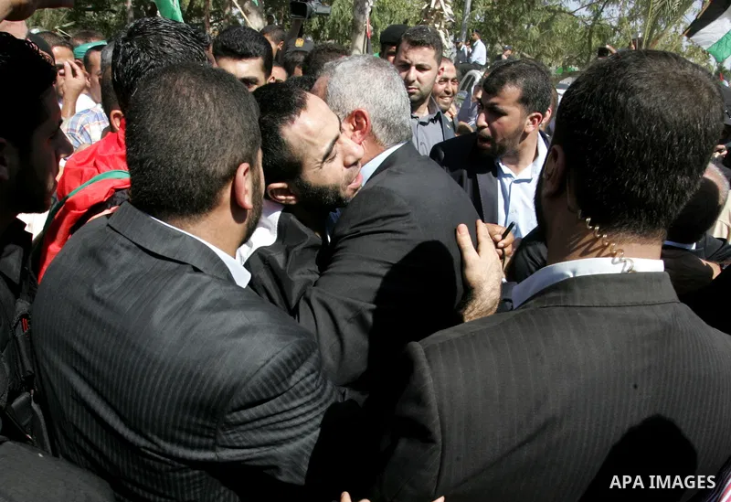Palestinian Prime Minister in Gaza Strip, Ismail Haniyeh greets a released Palestinian prisoner at the Rafah border crossing in southern Gaza Strip, Tuesday, Oct. 18, 2011. The Hamas militant group released an Israeli so...