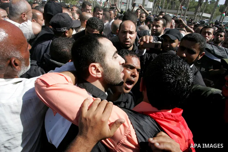 Palestinians greet their relative released Palestinian prisoner at the Rafah border crossing in southern Gaza Strip, Tuesday, Oct. 18, 2011. The Hamas militant group released an Israeli soldier Tuesday more than five yea...