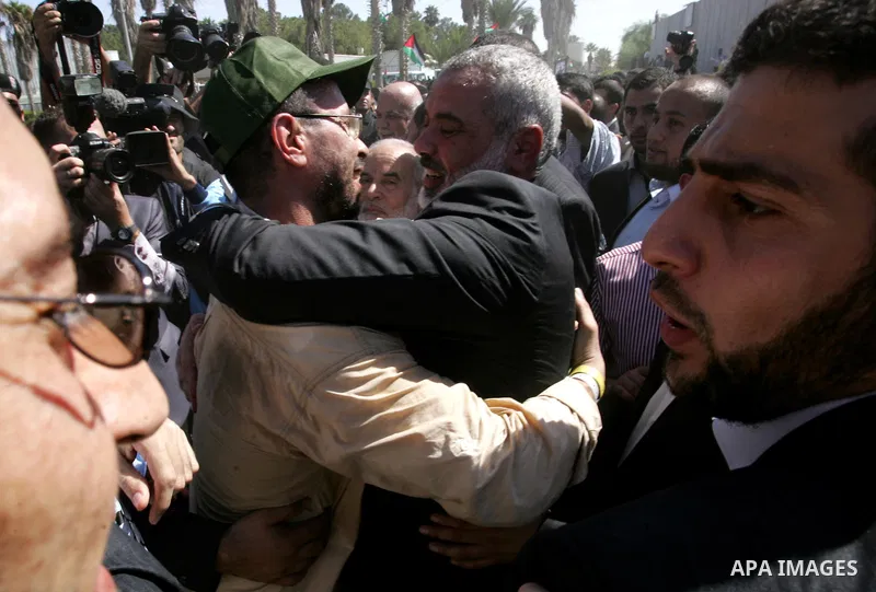 Palestinian Prime Minister in Gaza Strip, Ismail Haniyeh greets a released Palestinian prisoner at the Rafah border crossing in southern Gaza Strip, Tuesday, Oct. 18, 2011. The Hamas militant group released an Israeli so...