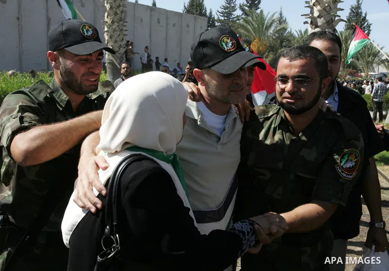 Palestinians greet their relative released Palestinian prisoner at the Rafah border crossing in southern Gaza Strip, Tuesday, Oct. 18, 2011. The Hamas militant group released an Israeli soldier Tuesday more than five yea...