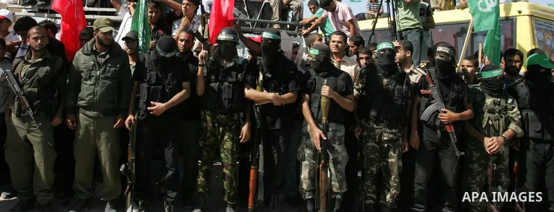 Hamas militants celebrate the release of prisoners at the Rafah border crossing in southern Gaza Strip, Tuesday, Oct. 18, 2011. Tens of thousands of flag-waving Palestinians on Tuesday celebrated the homecoming of hundre...