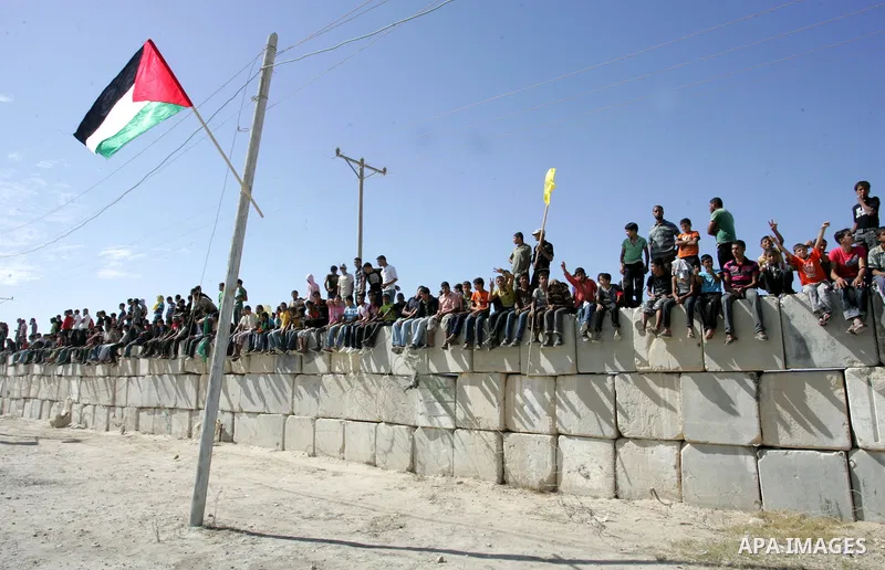 Palestinian youths celebrate the release of prisoners at the Rafah border crossing in southern Gaza Strip, Tuesday, Oct. 18, 2011. Tens of thousands of flag-waving Palestinians on Tuesday celebrated the homecoming of hun...