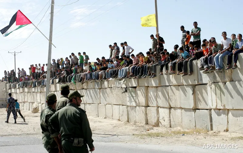 Palestinian youths celebrate the release of prisoners at the Rafah border crossing in southern Gaza Strip, Tuesday, Oct. 18, 2011. Tens of thousands of flag-waving Palestinians on Tuesday celebrated the homecoming of hun...
