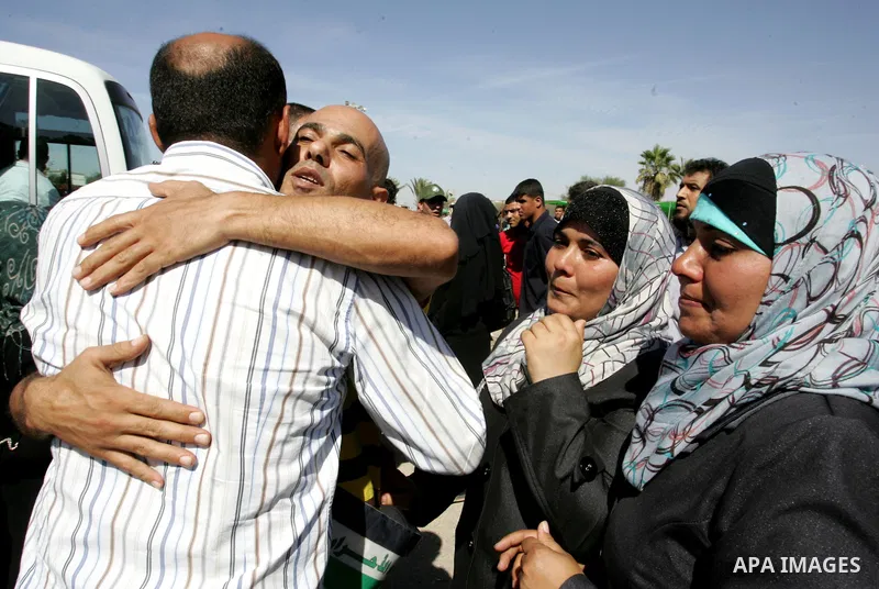 Palestinians greet their relative released Palestinian prisoner at the Rafah border crossing in southern Gaza Strip, Tuesday, Oct. 18, 2011. The Hamas militant group released an Israeli soldier Tuesday more than five yea...