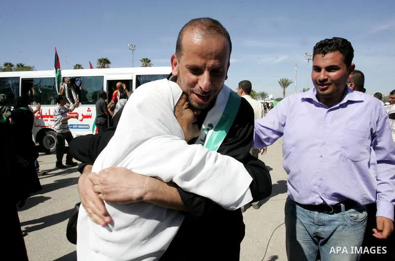 Palestinians greet their relative released Palestinian prisoner at the Rafah border crossing in southern Gaza Strip, Tuesday, Oct. 18, 2011. The Hamas militant group released an Israeli soldier Tuesday more than five yea...