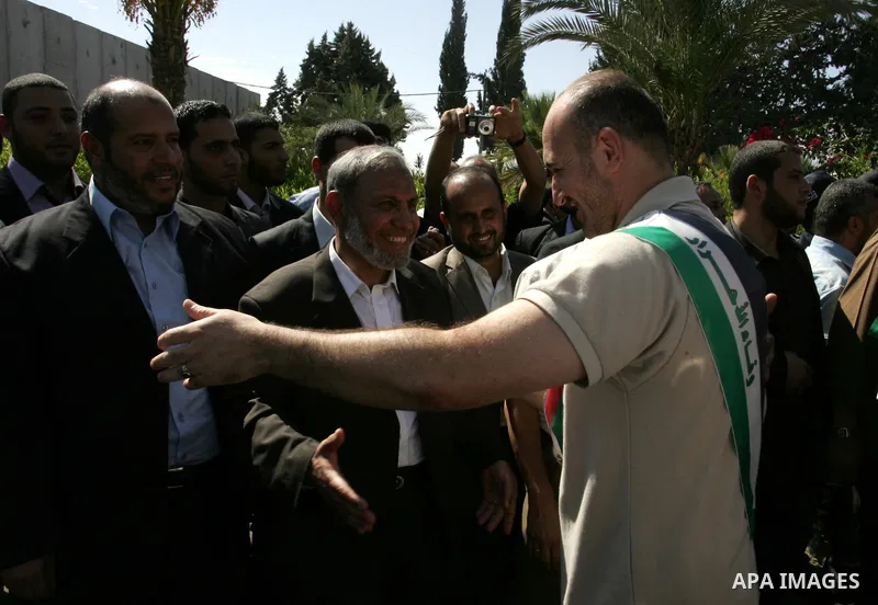 Palestinian Hamas leader, Mahmoud al-Zahar greets a released Palestinian prisoner at the Rafah border crossing in southern Gaza Strip, Tuesday, Oct. 18, 2011. The Hamas militant group released an Israeli soldier Tuesday...