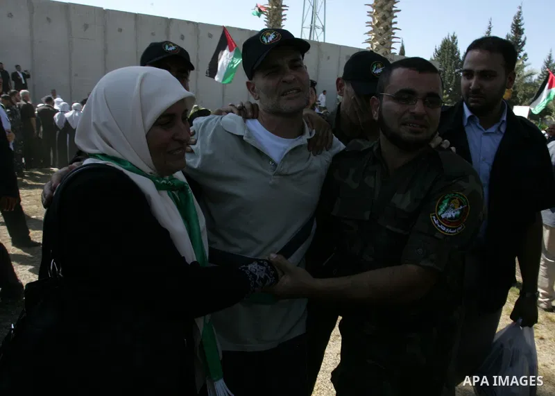 Palestinians greet their relative released Palestinian prisoner at the Rafah border crossing in southern Gaza Strip, Tuesday, Oct. 18, 2011. The Hamas militant group released an Israeli soldier Tuesday more than five yea...