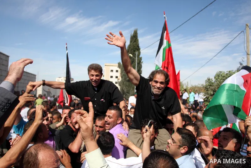 A Palestinian prisoner is welcomed by a crowd following the release of hundreds of prisoners from Israeli jails on October 18,2011 at the Palestinian Authority headquarters in the West Bank city of Ramallah. Crowds of Pa...