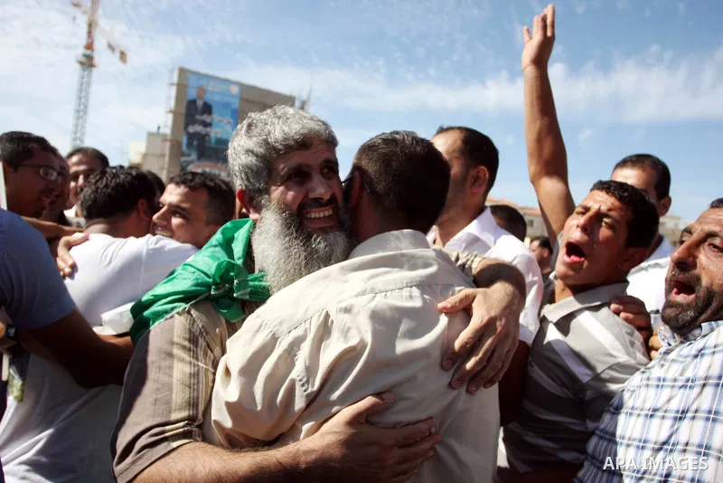 A Palestinian prisoner is welcomed by a crowd following the release of hundreds of prisoners from Israeli jails on October 18,2011 at the Palestinian Authority headquarters in the West Bank city of Ramallah. Crowds of Pa...