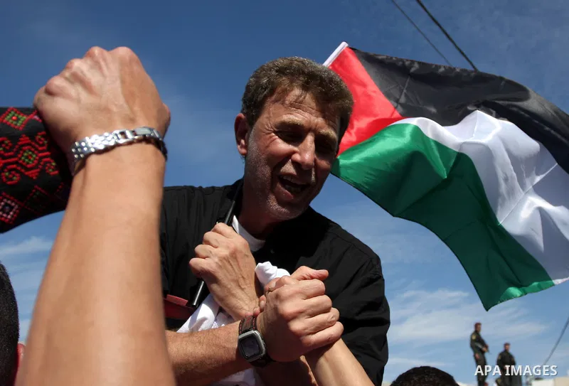 A Palestinian prisoner is welcomed by a crowd following the release of hundreds of prisoners from Israeli jails on October 18,2011 at the Palestinian Authority headquarters in the West Bank city of Ramallah. Crowds of Pa...