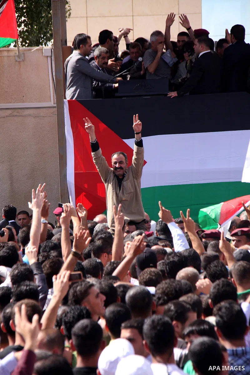 Freed Palestinian prisoners (C) are welcomed home by their friends and relatives upon their arrival in Ramallah, the West Bank, 18 October 2011. 477 Palestinian prisoners were freed on 18 October 2011 in exchange for the...