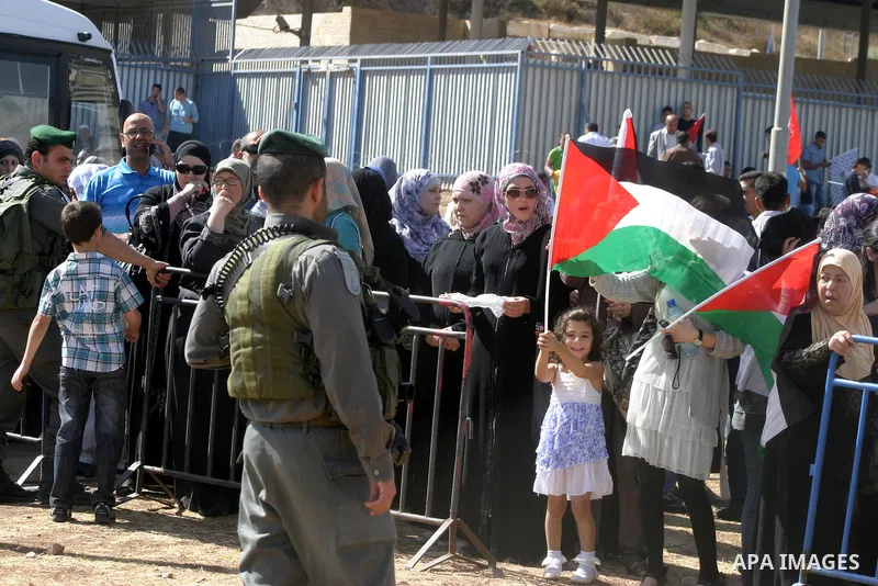 Palestinians wait for former prisoners to be released in East Jerusalem from Israeli prison, Tuesday, Oct. 18, 2011. Hamas agreed to release Israeli soldier Galit Schalit in exchange for 1,027 Palestinian prisoners, many...
