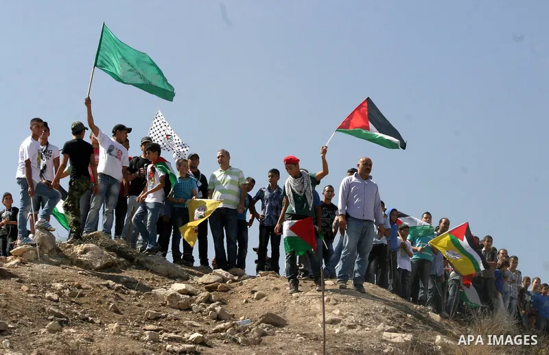 Palestinians wait for former prisoners to be released in East Jerusalem from Israeli prison, Tuesday, Oct. 18, 2011. Hamas agreed to release Israeli soldier Galit Schalit in exchange for 1,027 Palestinian prisoners, many...